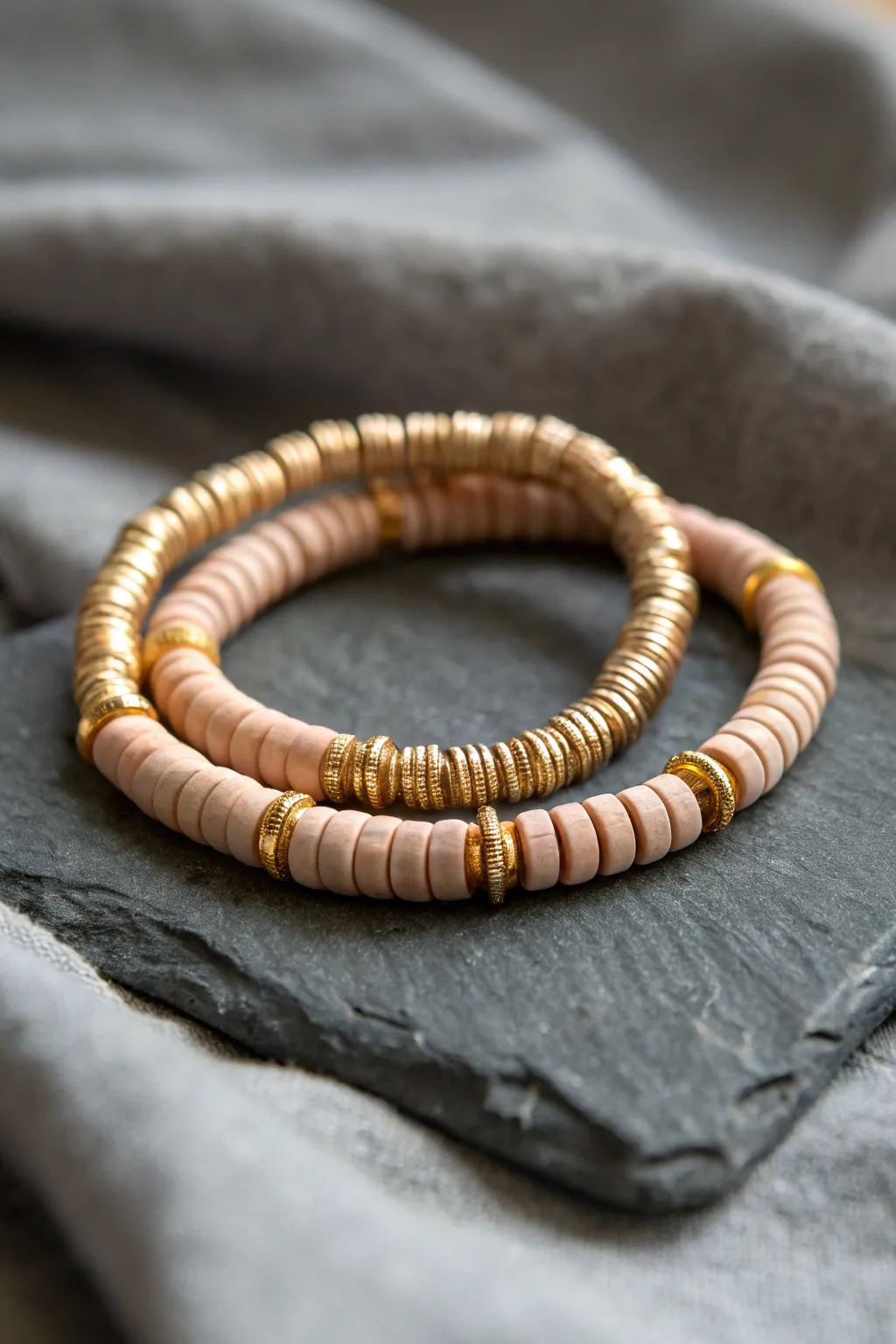 Minimal neutral heishi bracelet with repeating gold spacers for a soft, modern rhythm
