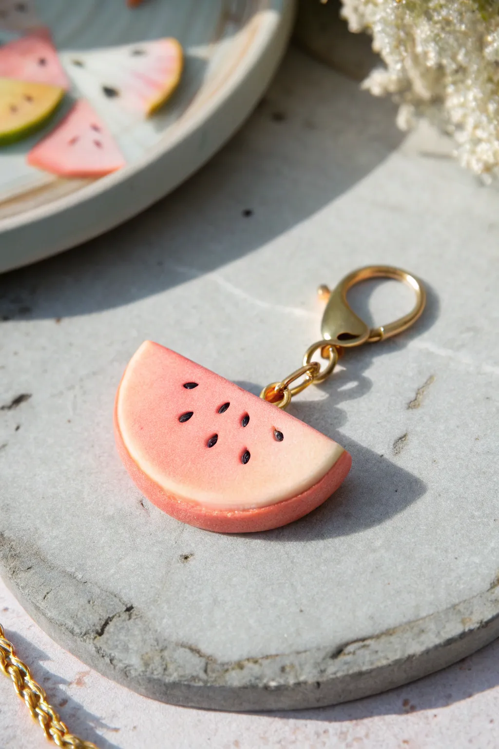 Peachy-pink polymer clay fruit slice charm with soft gradients, minimalist and boho-sweet.