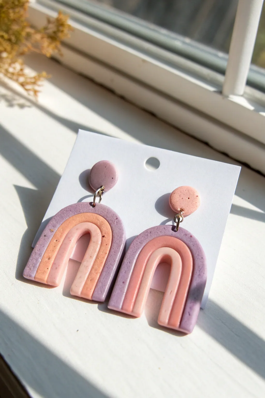 Pastel ombre polymer clay dangles on a clean white card, minimalist boho color pop