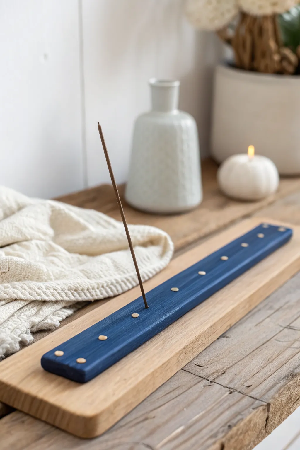 Sleek cobalt polymer clay incense holder with tiny dots, styled on a serene Scandinavian shelf.