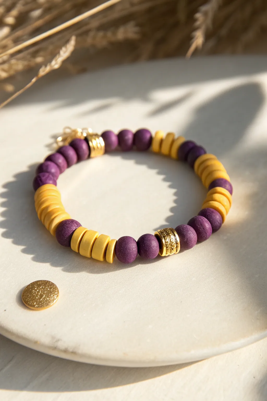 Bold purple and marigold clay disc bead bracelet, minimalist styling with a chic boho color pop.