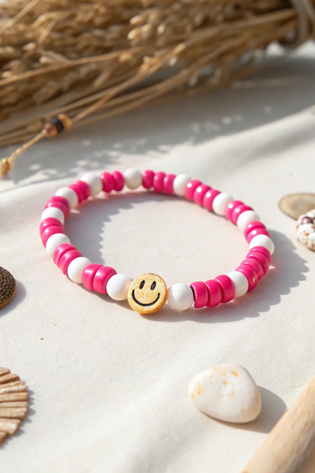 Cheerful preppy clay bead bracelet with smiley centerpiece and crisp pink-white discs.