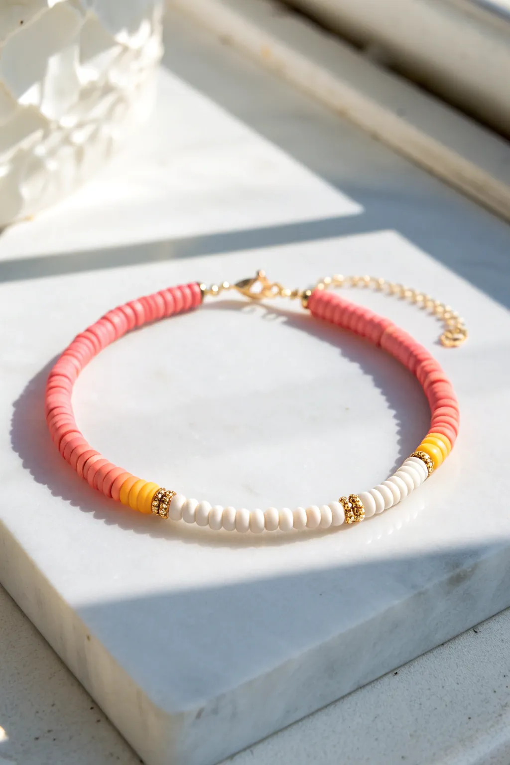 Sunset ombre heishi bracelet in hot pink to coral to buttery yellow with crisp white accents