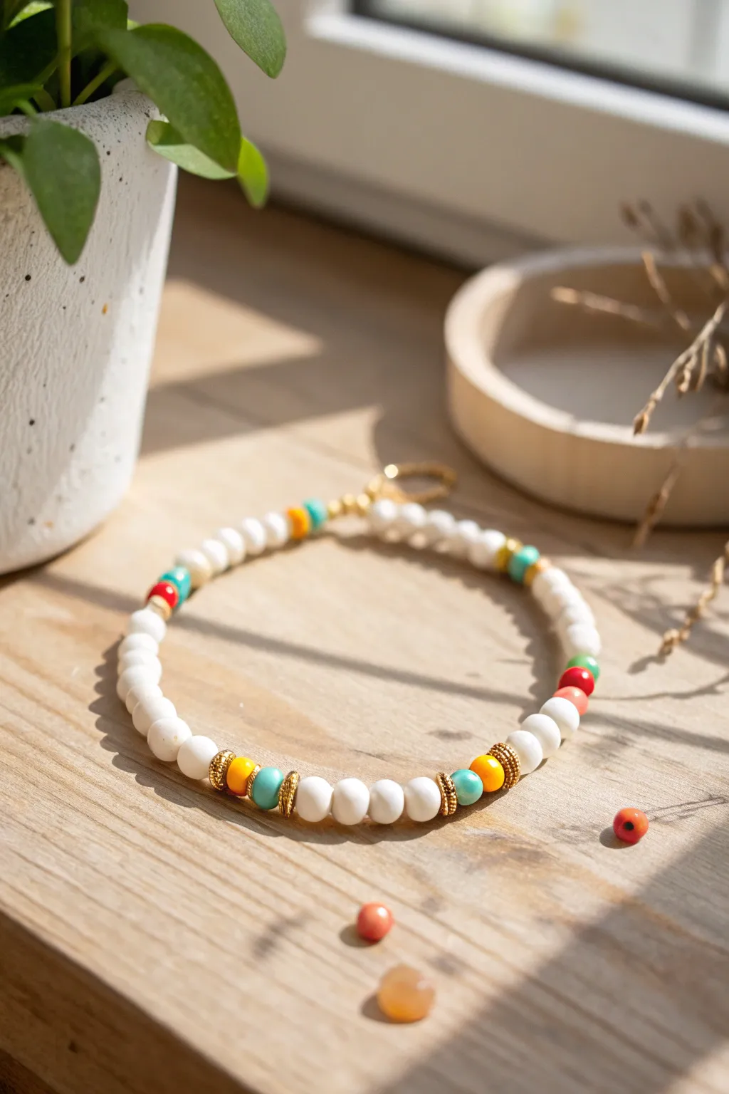 Mostly white clay beads with confetti pops and gold spacers for a preppy-cute bracelet