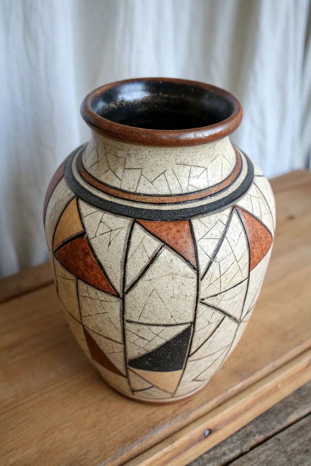 Wax-resist raku jar with crisp clean shapes, bold black reduction, delicate crackle contrast