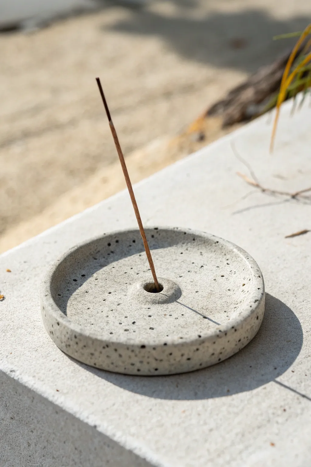Minimal speckled clay incense holder disc with a single stick, Scandinavian boho calm.