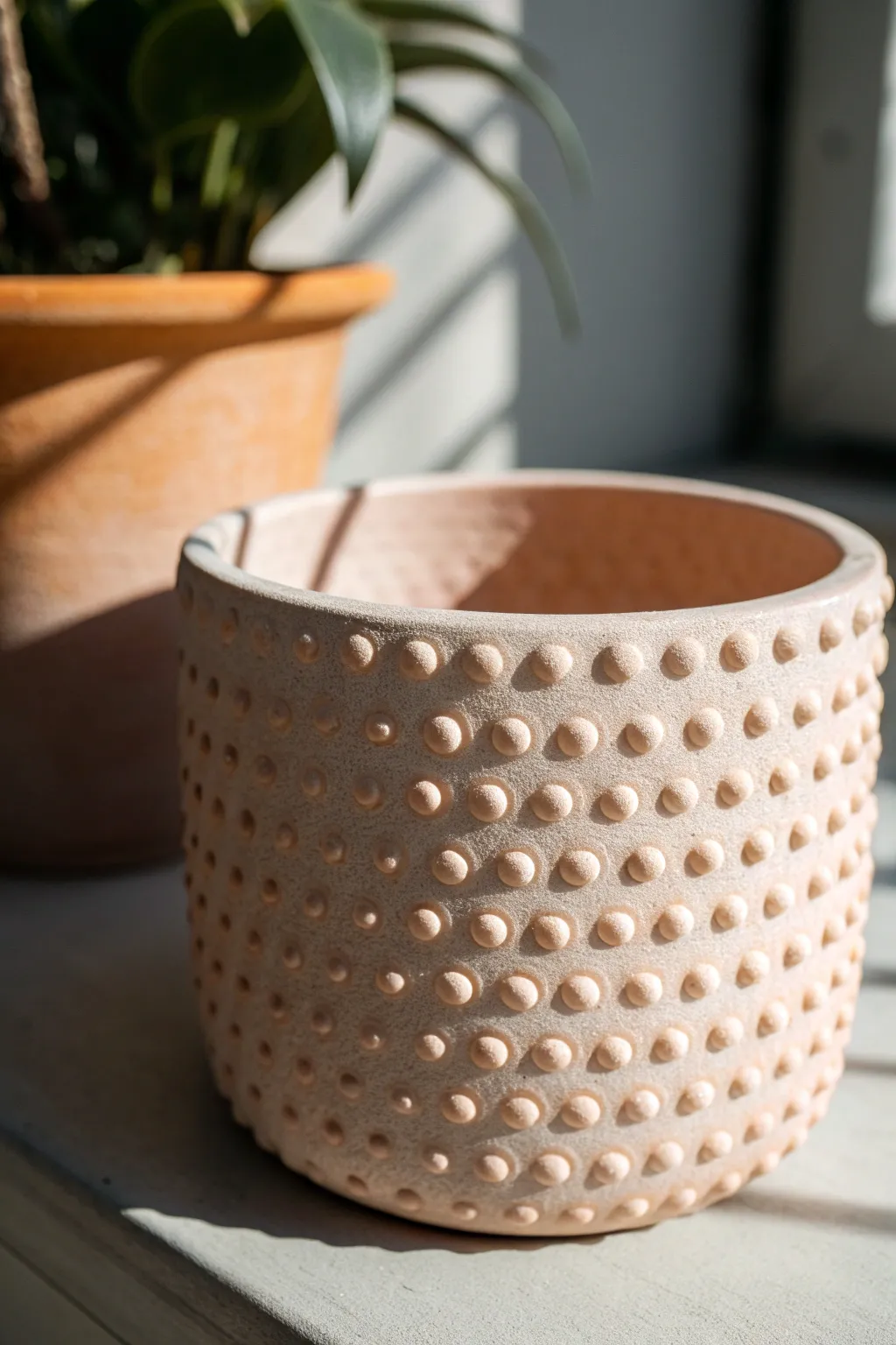 Pebble dimple texture turns a simple planter into a bold, tactile statement with cozy shadows.