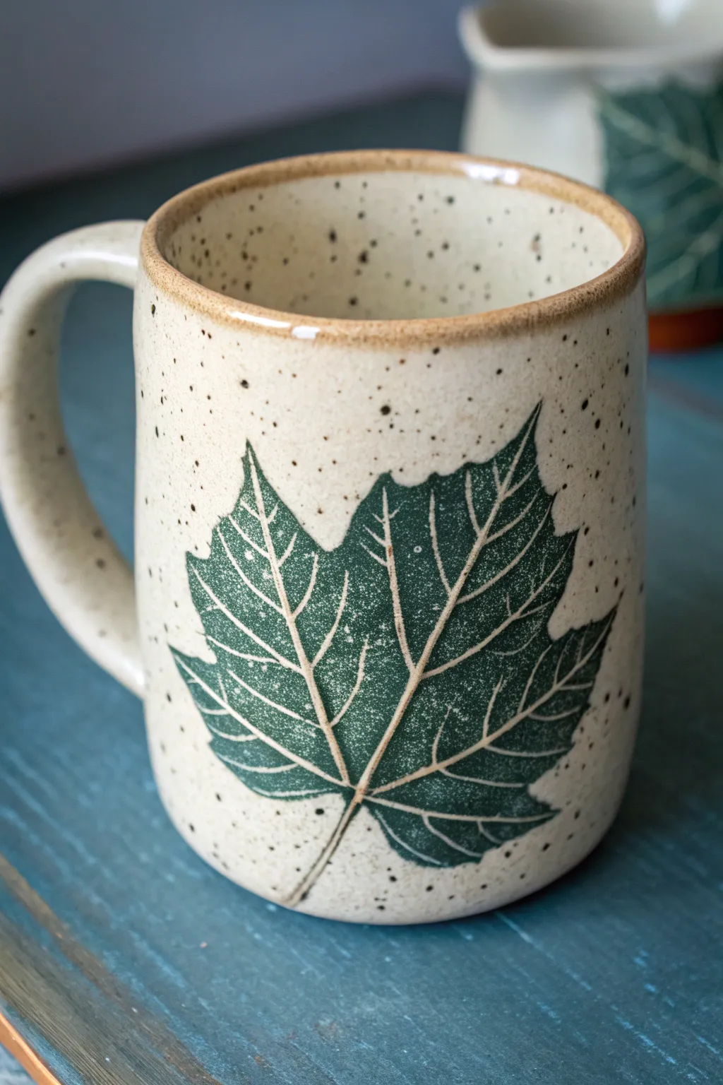 Minimal slab mug with a bold leaf imprint and clear glaze for crisp, botanical texture.