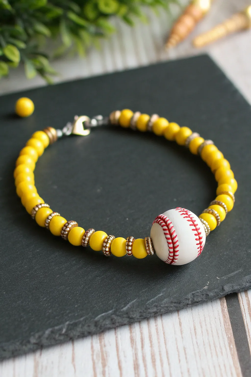 Softball uniform vibes in a sunny heishi bracelet with sleek metallic spacers and a stitched charm