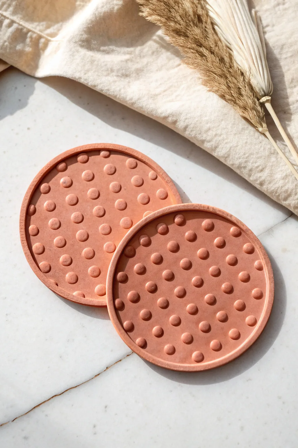 Bubble-dot super clay coasters in bold terracotta and blush, minimal and satisfying texture