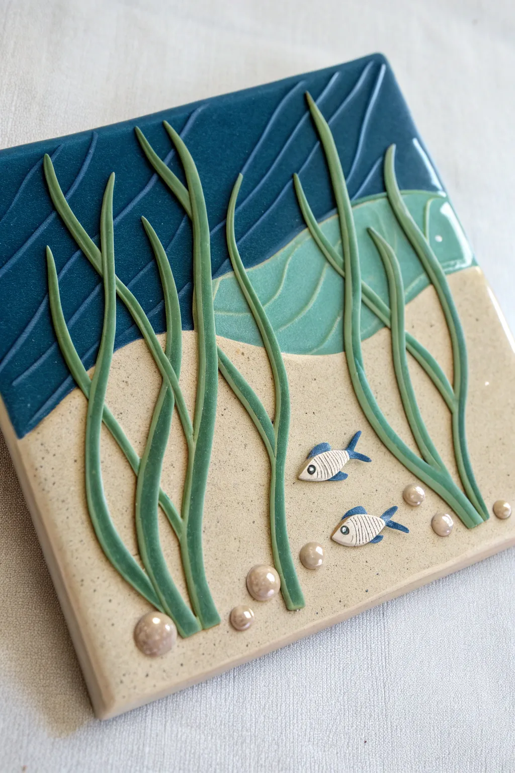 Spaghetti seaweed clay relief in bold greens over deep navy, simple and dreamy undersea depth.