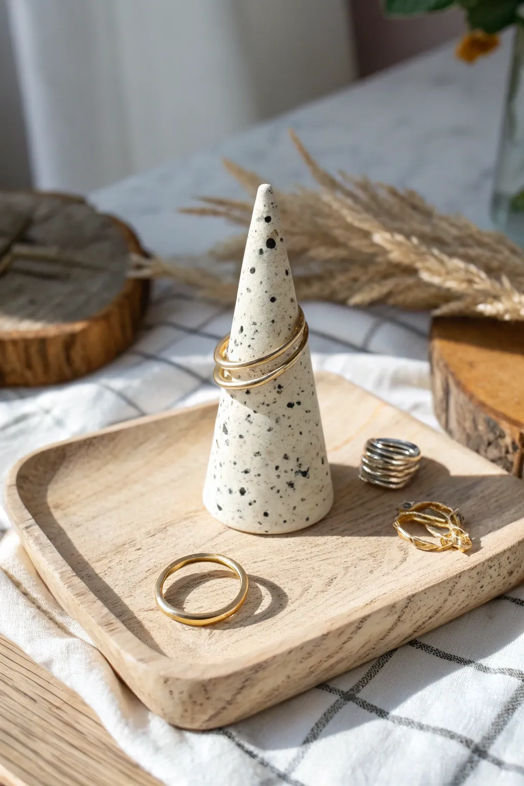 Speckled polymer clay ring cone with stacked rings, minimalist bedside styling with boho warmth.