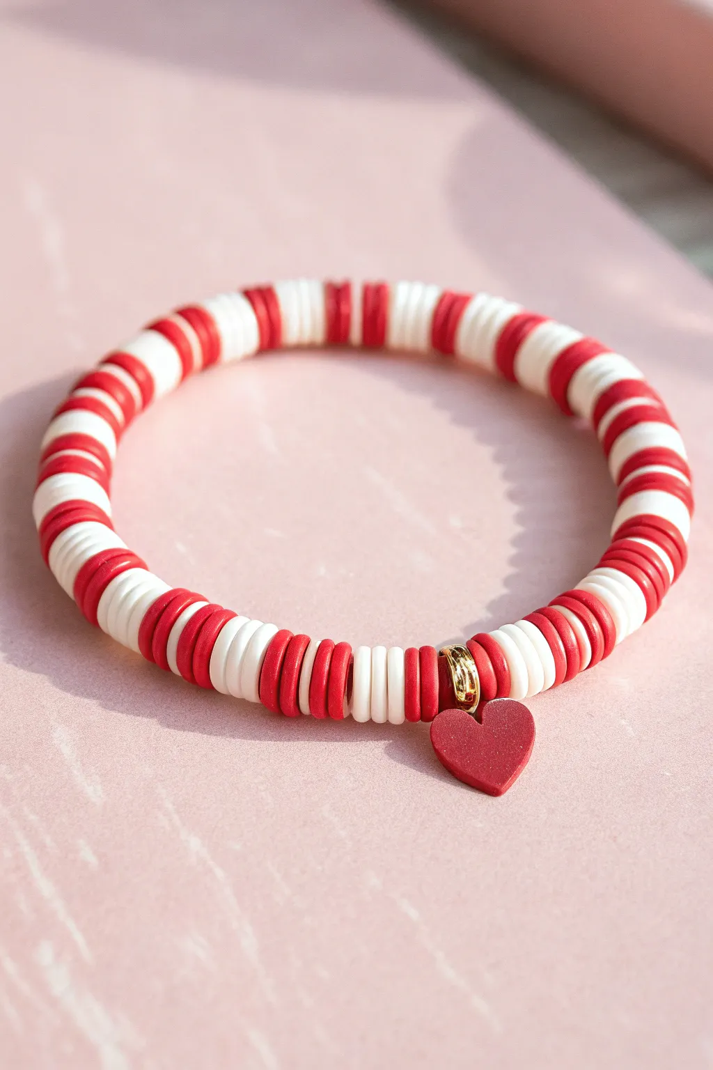 Sweet red and white heishi bracelet with a tiny heart centerpiece, perfect for Valentines gifting