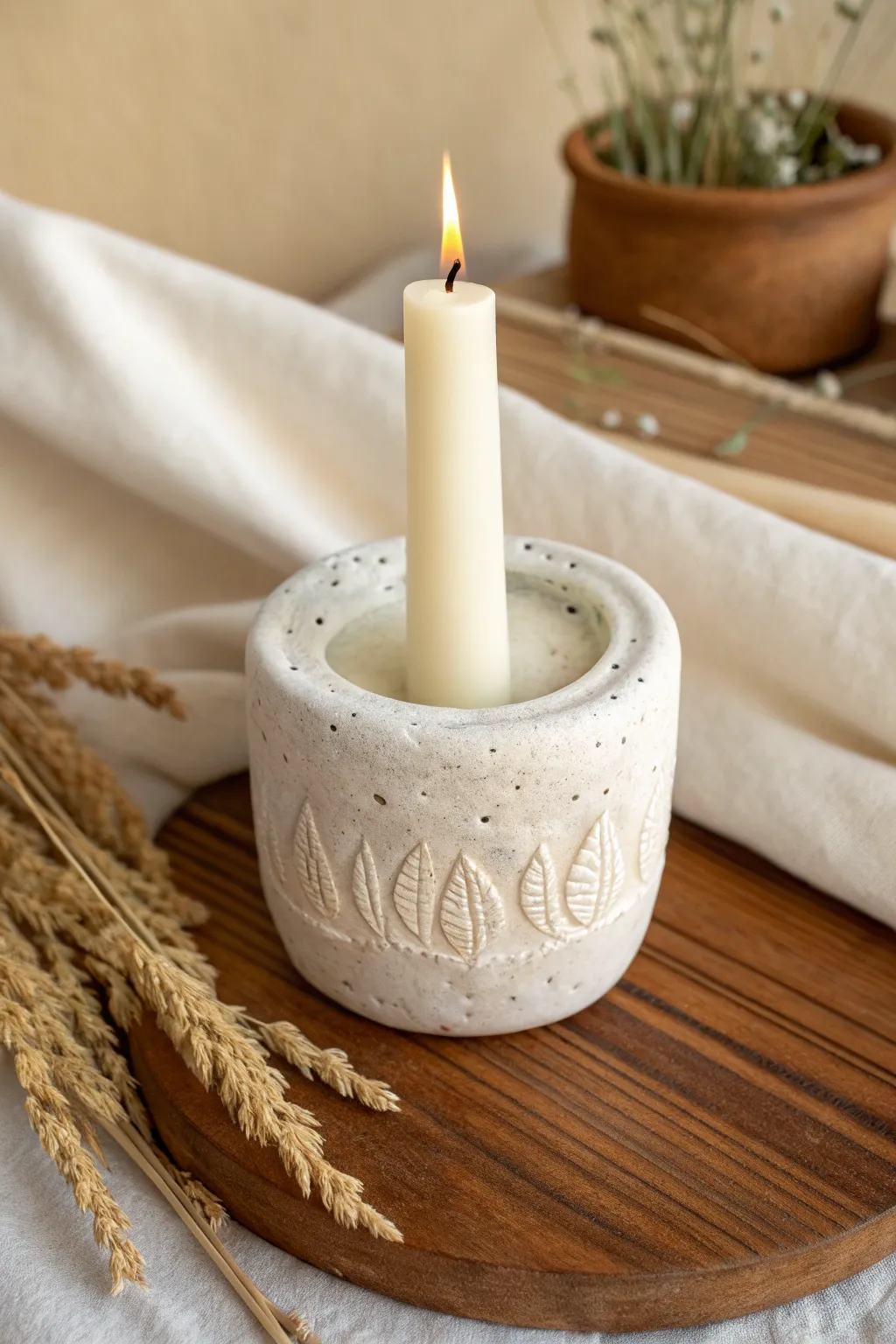 Soft-edged air clay candle holder with pressed patterns, minimalist boho warmth.