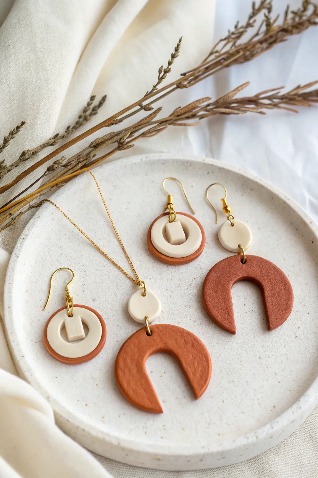 Air dry clay earrings and pendant with clean cutouts, minimalist Scandinavian boho elegance.