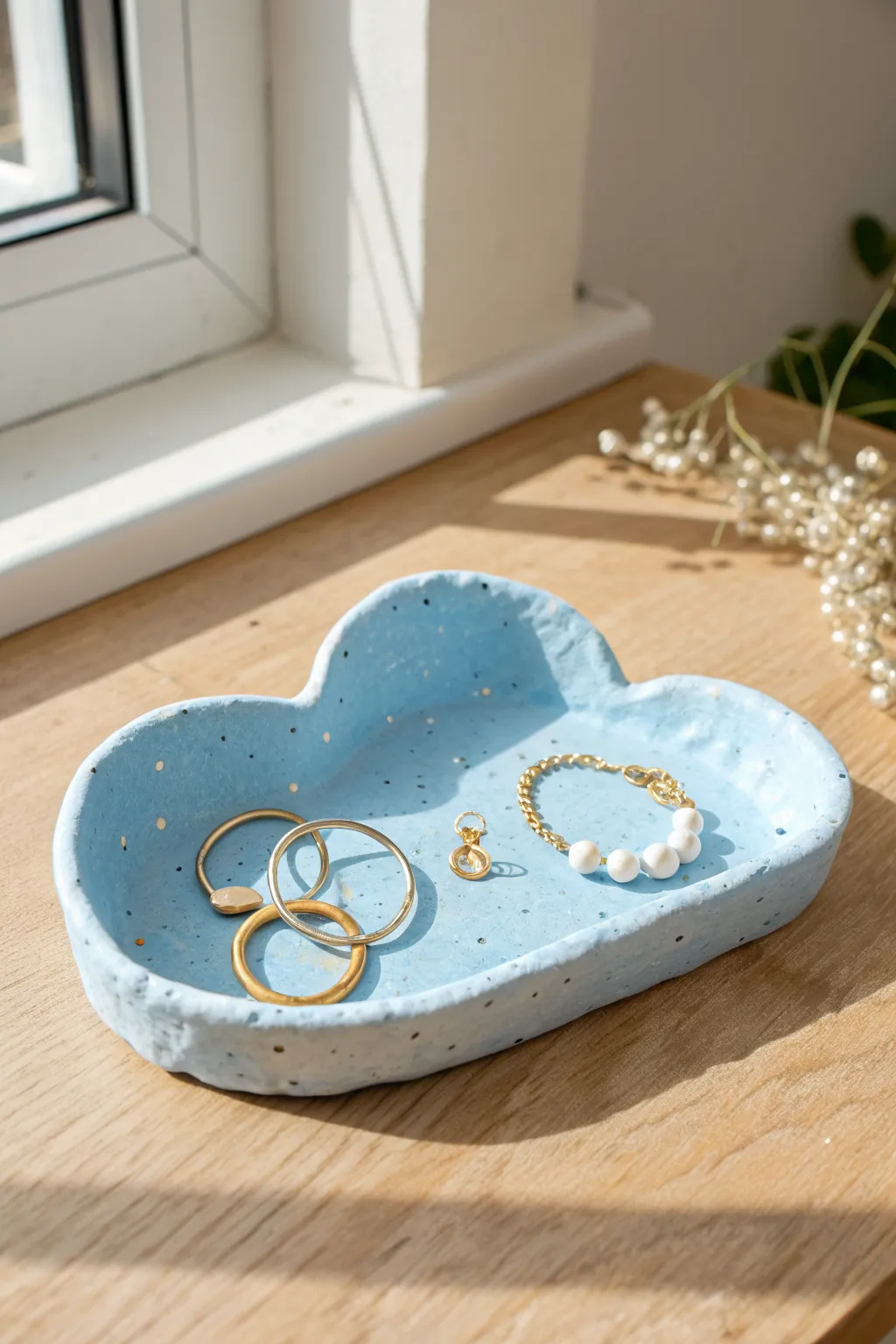 Puffy blue cloud catch-all tray with white highlights, perfect for earrings and bracelets.