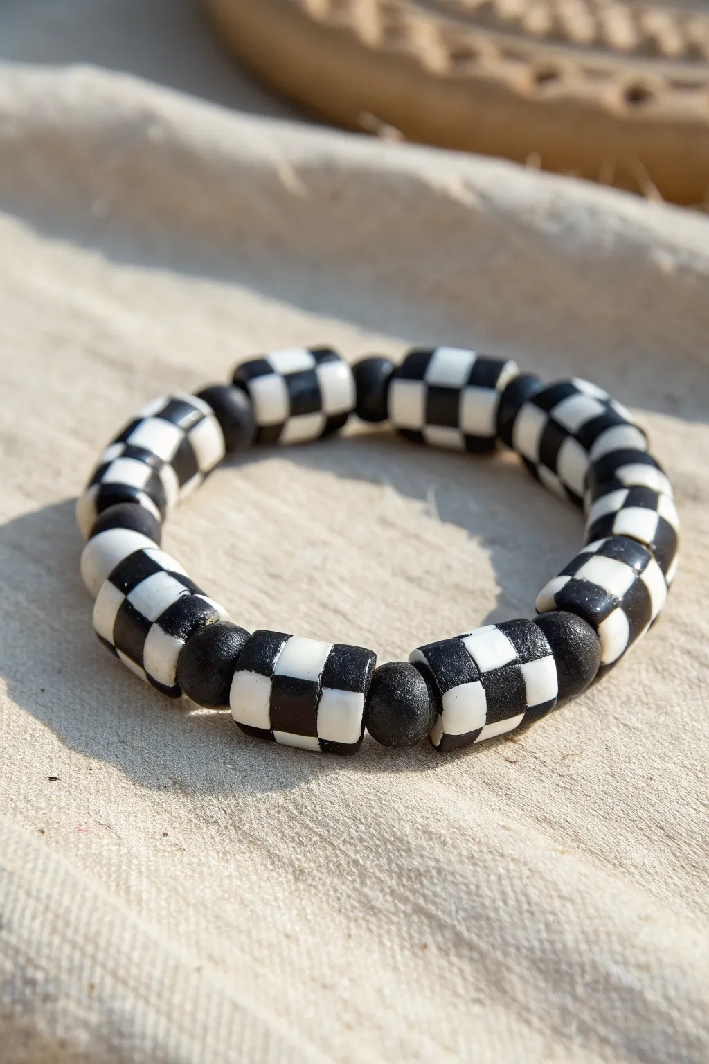 Skate inspired black and white clay bead bracelet with bold checker pattern, minimalist style.