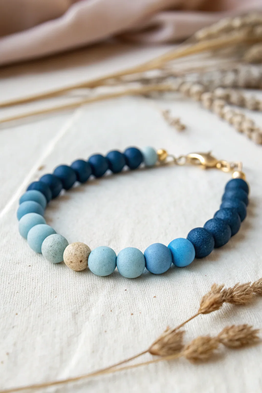 One-color ombre clay bead bracelet, fading from navy to sky blue for a clean modern look.