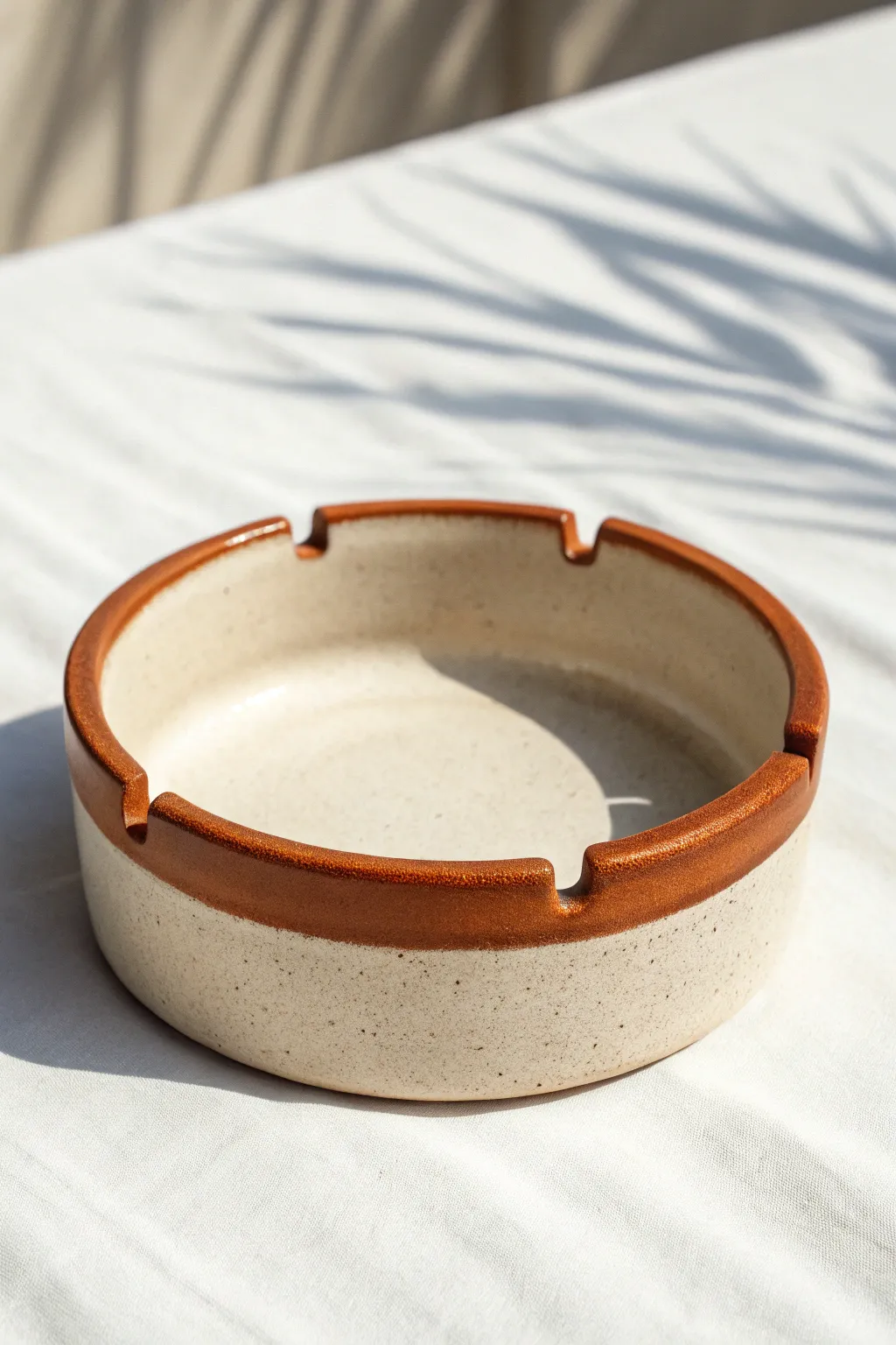Minimal two-tone dip-glazed rim ashtray with clean glaze break and simple notches