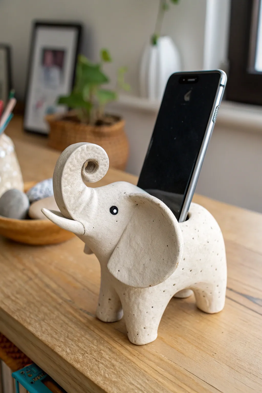 A sweet clay elephant sound funnel that amps your phone naturally, calm, minimal, and desk-ready.