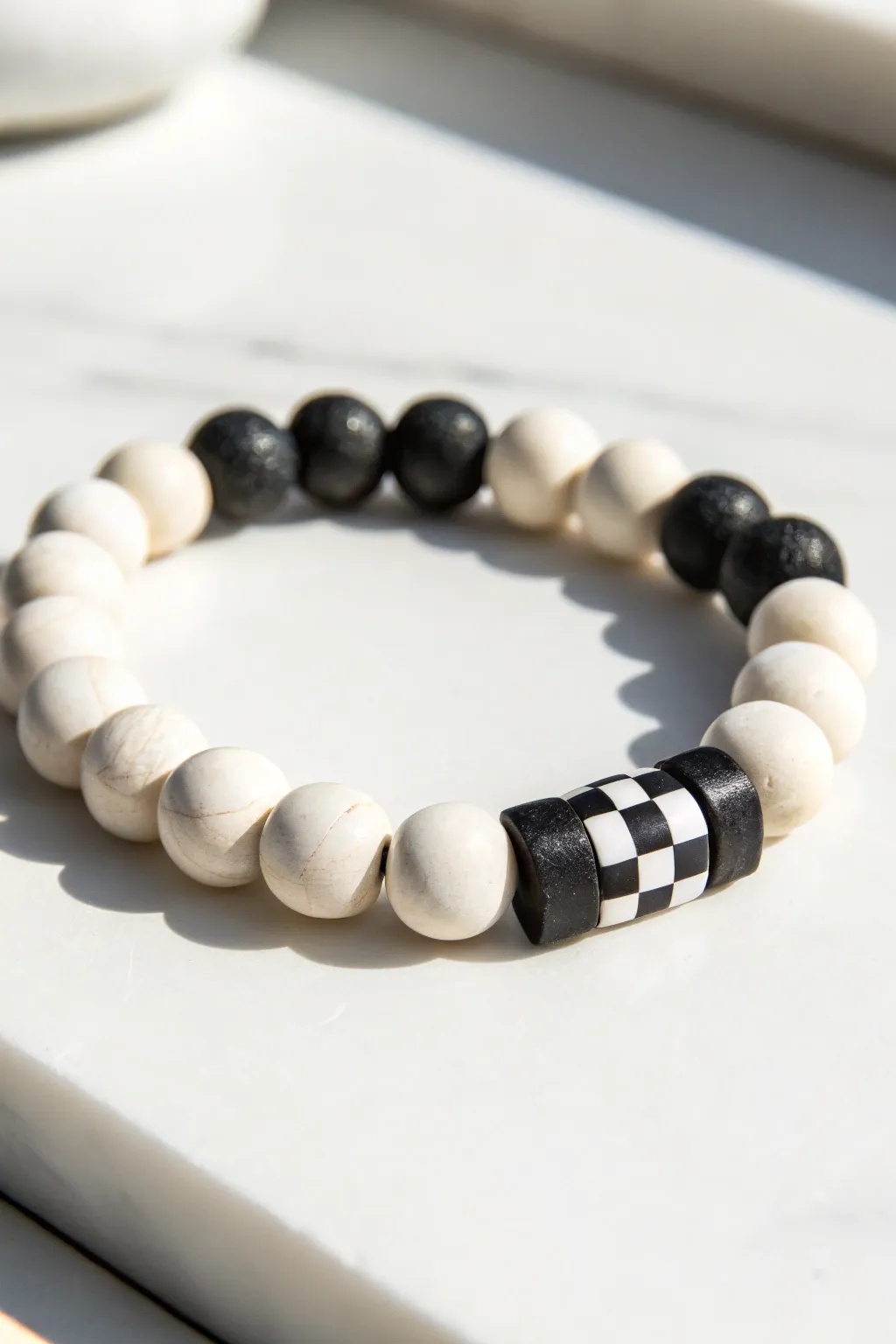 Minimalist black and white clay bead bracelet with bold checker block detail for modern boho style.