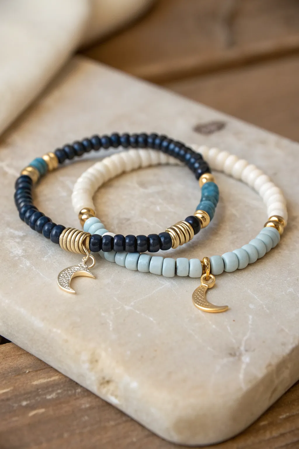 Night-sky clay bead stack with moon and star charms in minimalist Scandinavian boho style