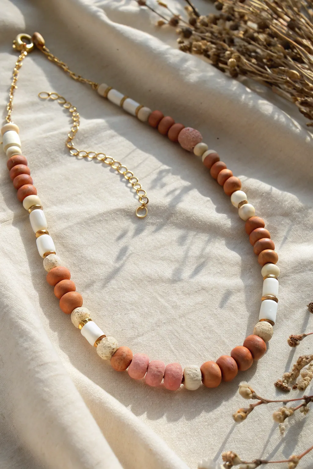 Linked clay bead segments with jump-ring connectors for a clean minimalist boho statement