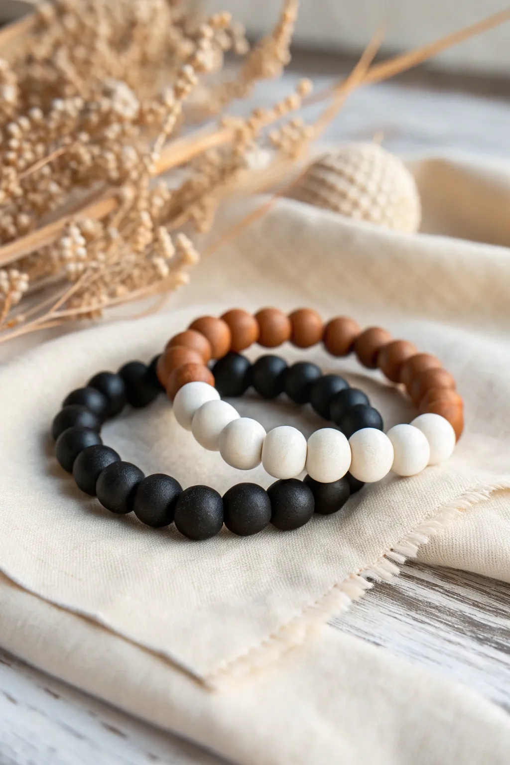 Checkerboard clay bead bracelets paired with a single bold accent for a clean graphic look