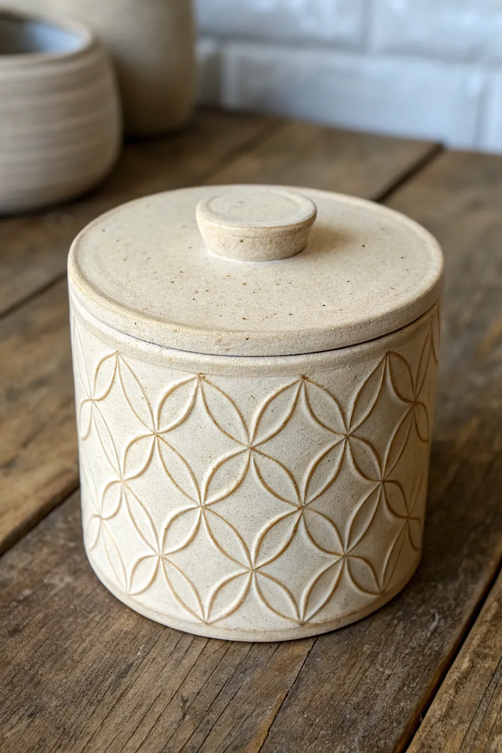 Stamped texture clay box with a clean lid band, minimalist and warm with crisp contrast