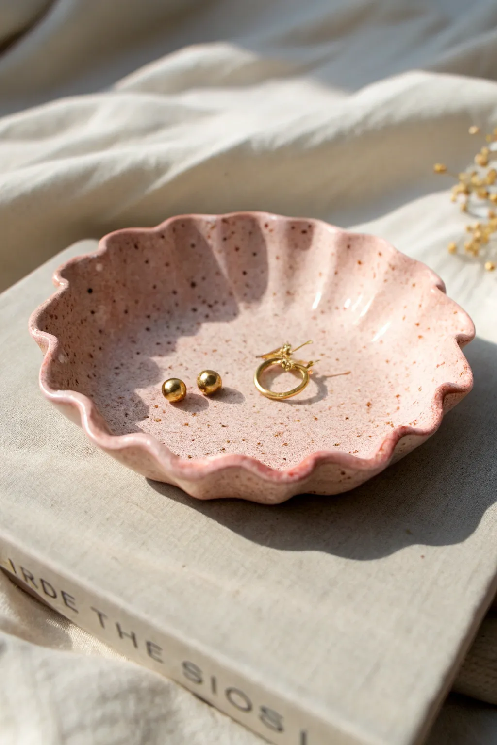 Sweet scalloped clay trinket dish in pastel blush, perfect for holding tiny earrings and rings.