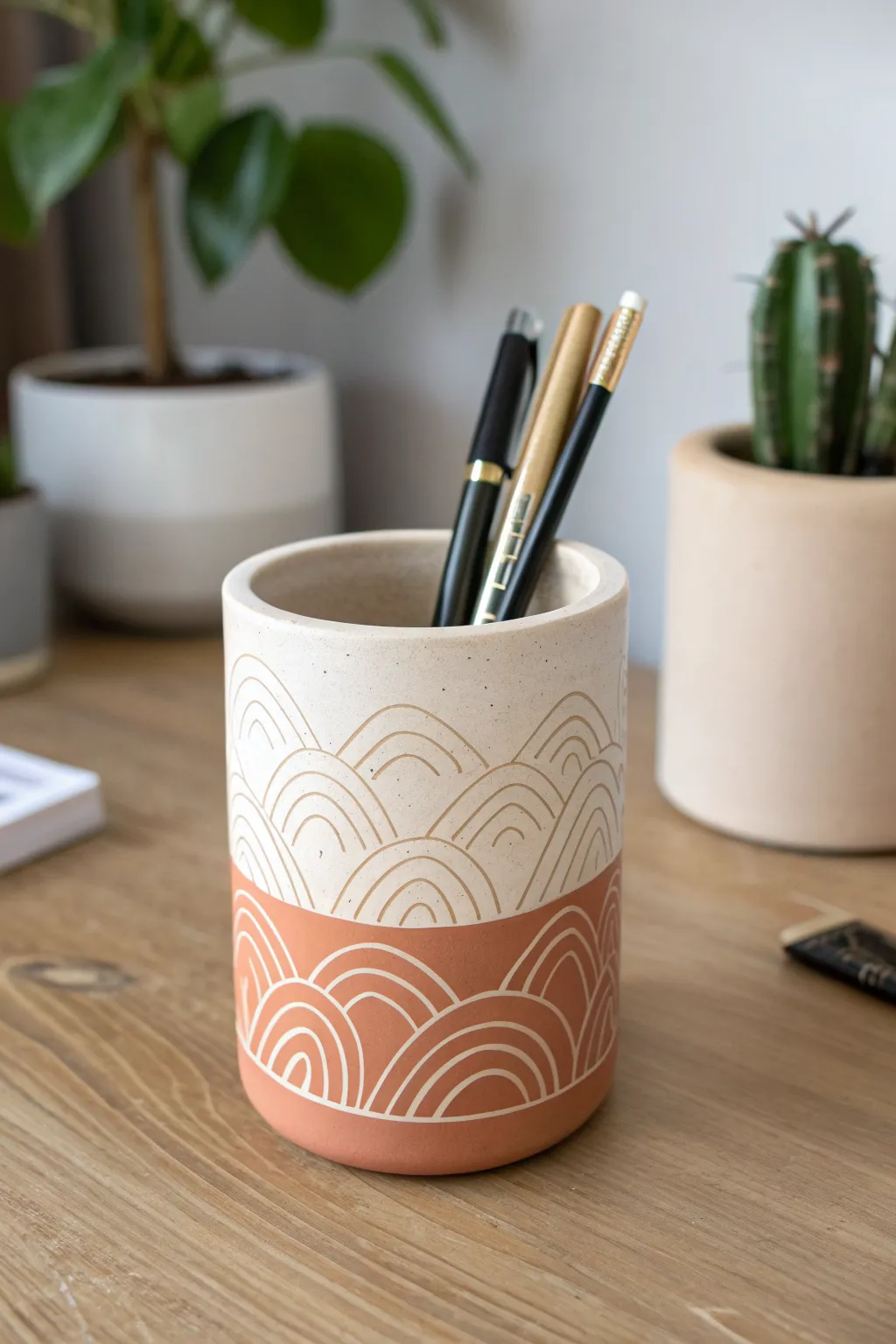 Matte sgraffito pen cup with carved lines and a chic mix of black and metallic pens