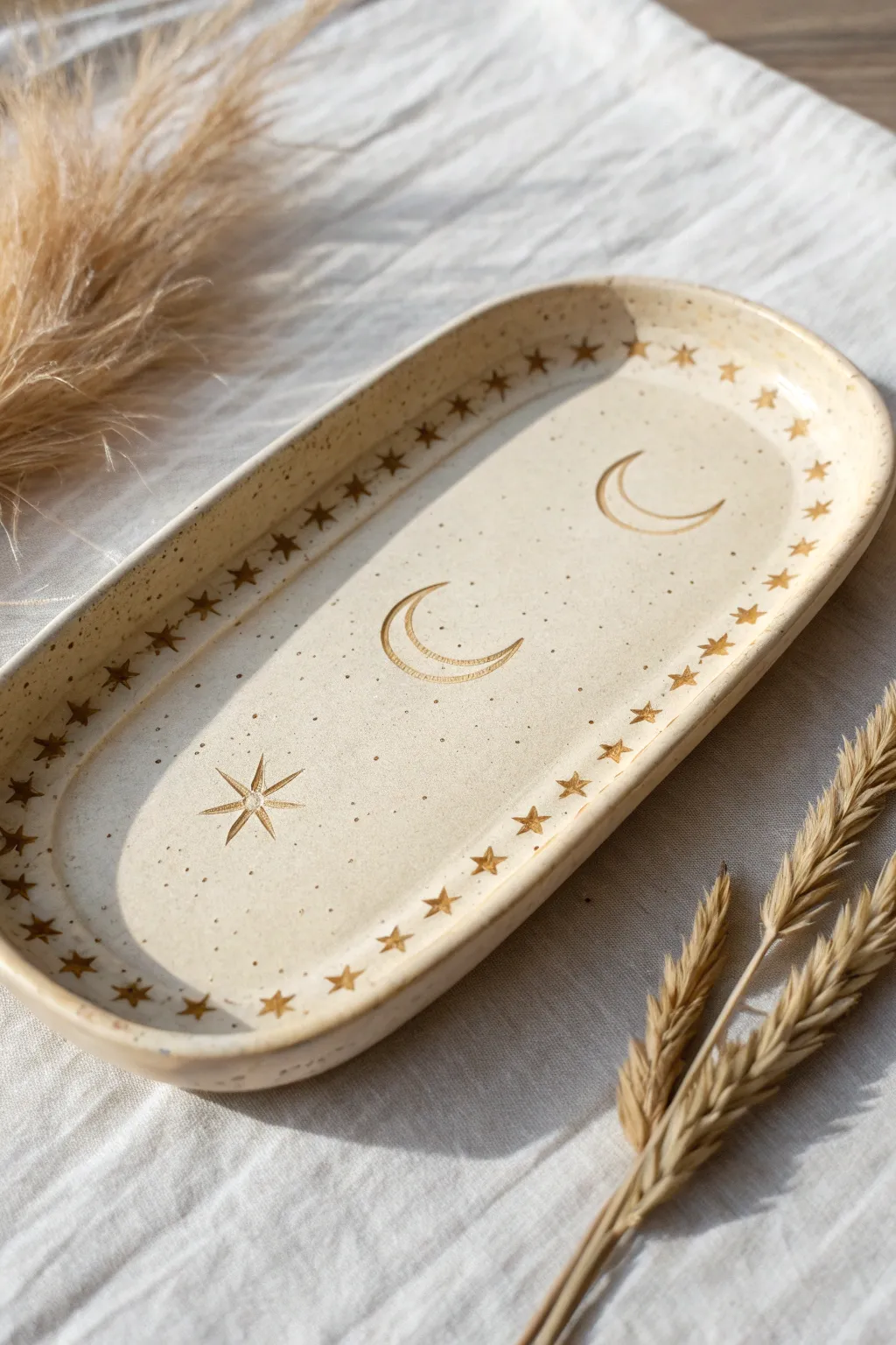 Minimal moon-and-stars clay rolling tray with a clean center and calm Scandinavian-boho vibe