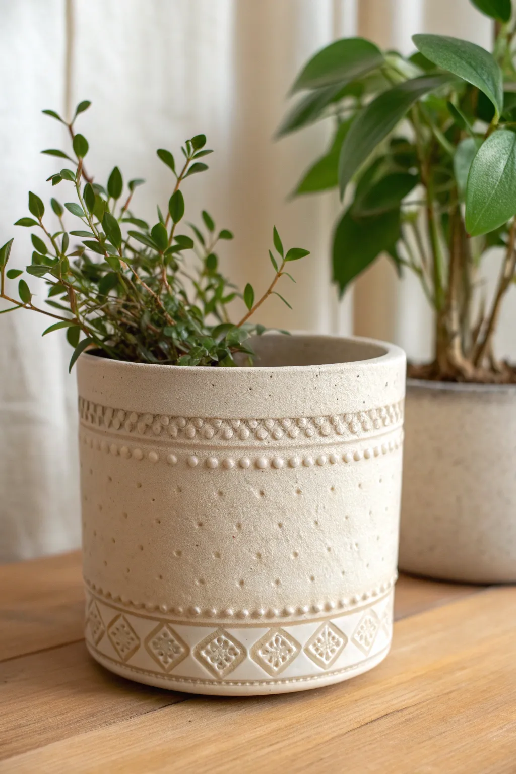 Simple appliqué sprigs and dots add an easy, handmade relief band to a minimalist planter.