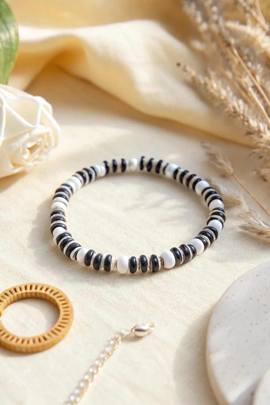Black-and-white clay disc beads in a dainty repeat for a crisp, minimalist bracelet look.