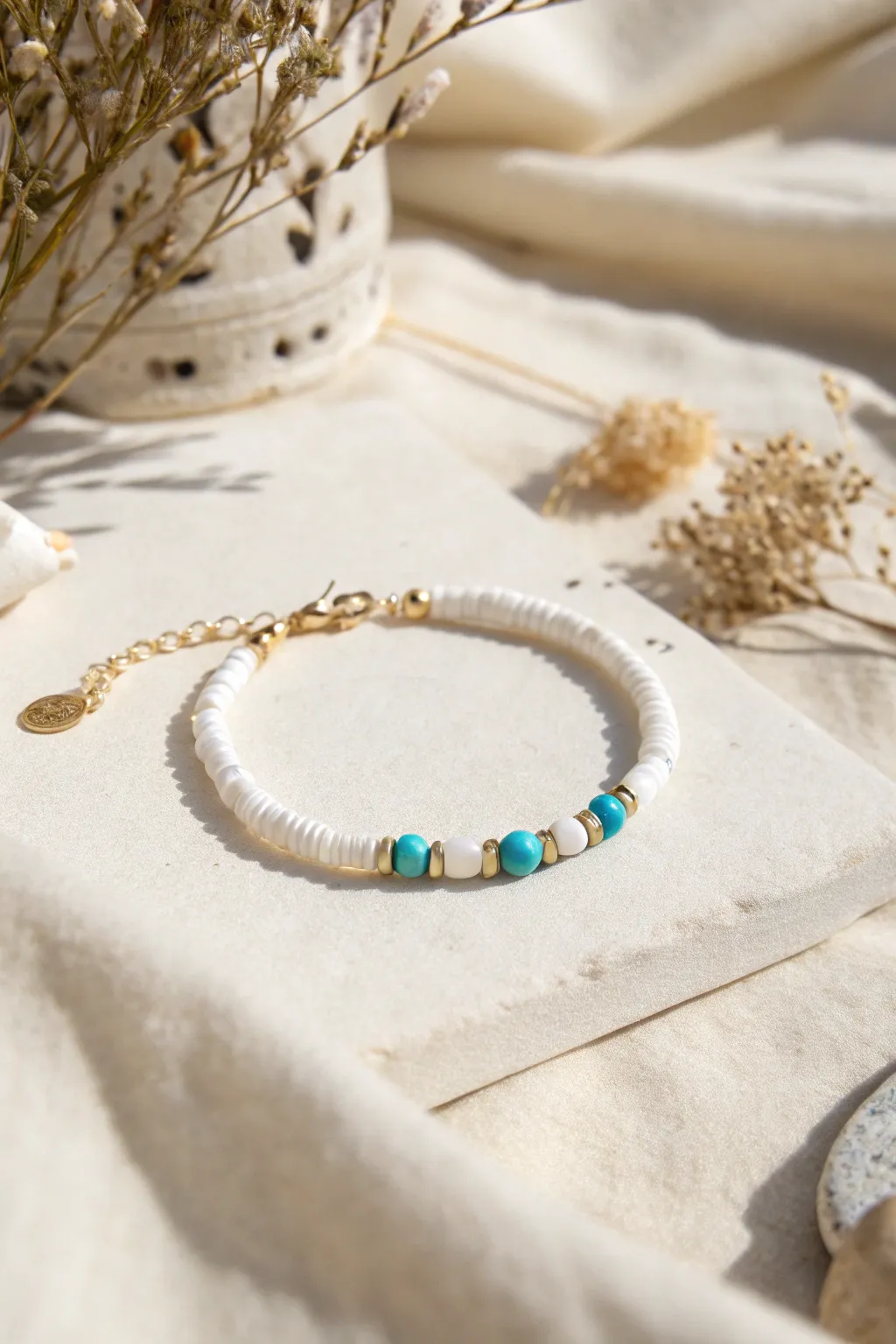 Classic white heishi bracelet with a bright aqua pop color for a simple, cute clay bead idea