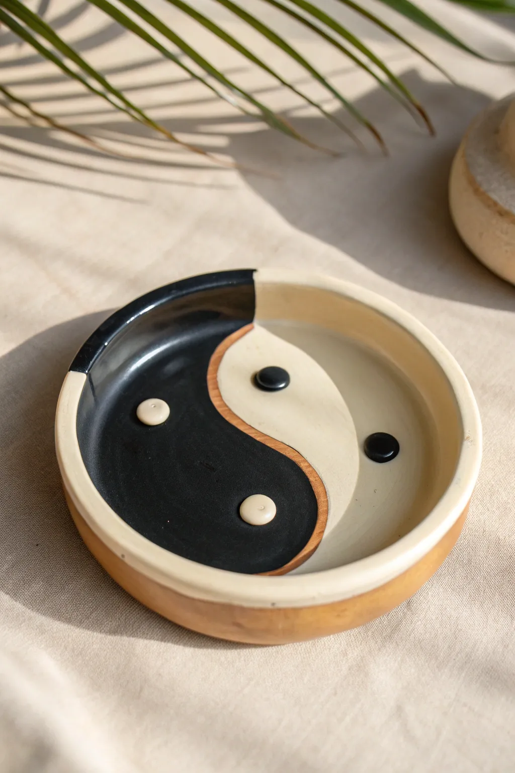 Minimal yin-yang split color clay ashtray with crisp edges and a softly glossy finish