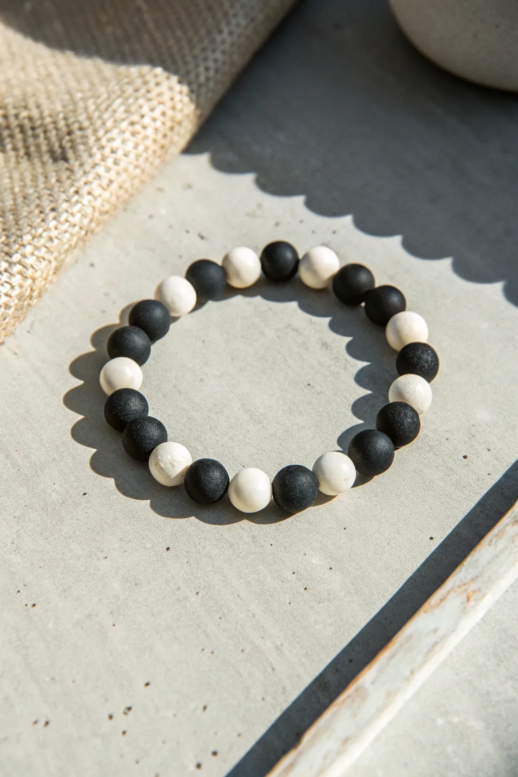 Bold black and white clay bead bracelet with a crisp pattern for an easy modern DIY.