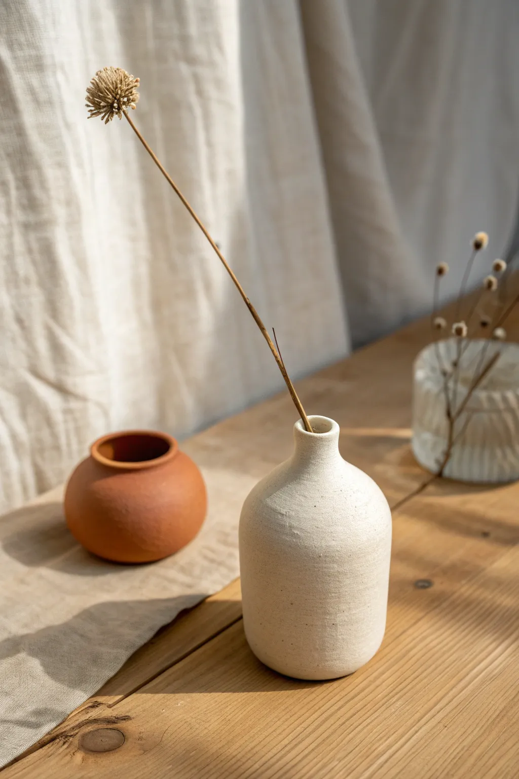 Minimalist clay bud vase with a single stem, simple shapes and soft boho tones for beginners