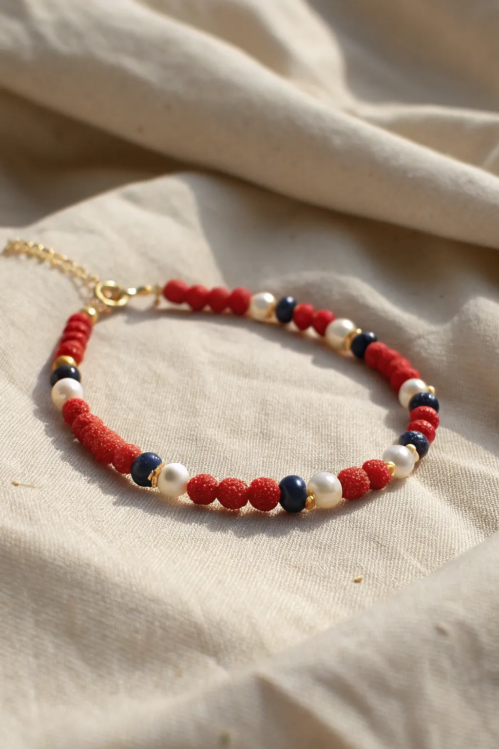 Pearls meet red and blue clay discs for a dressy Americana bracelet with clean minimalist charm