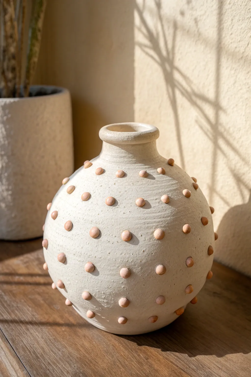 Soft pastel dot-and-ball appliqué vase in minimalist Scandinavian style with a cozy boho touch.