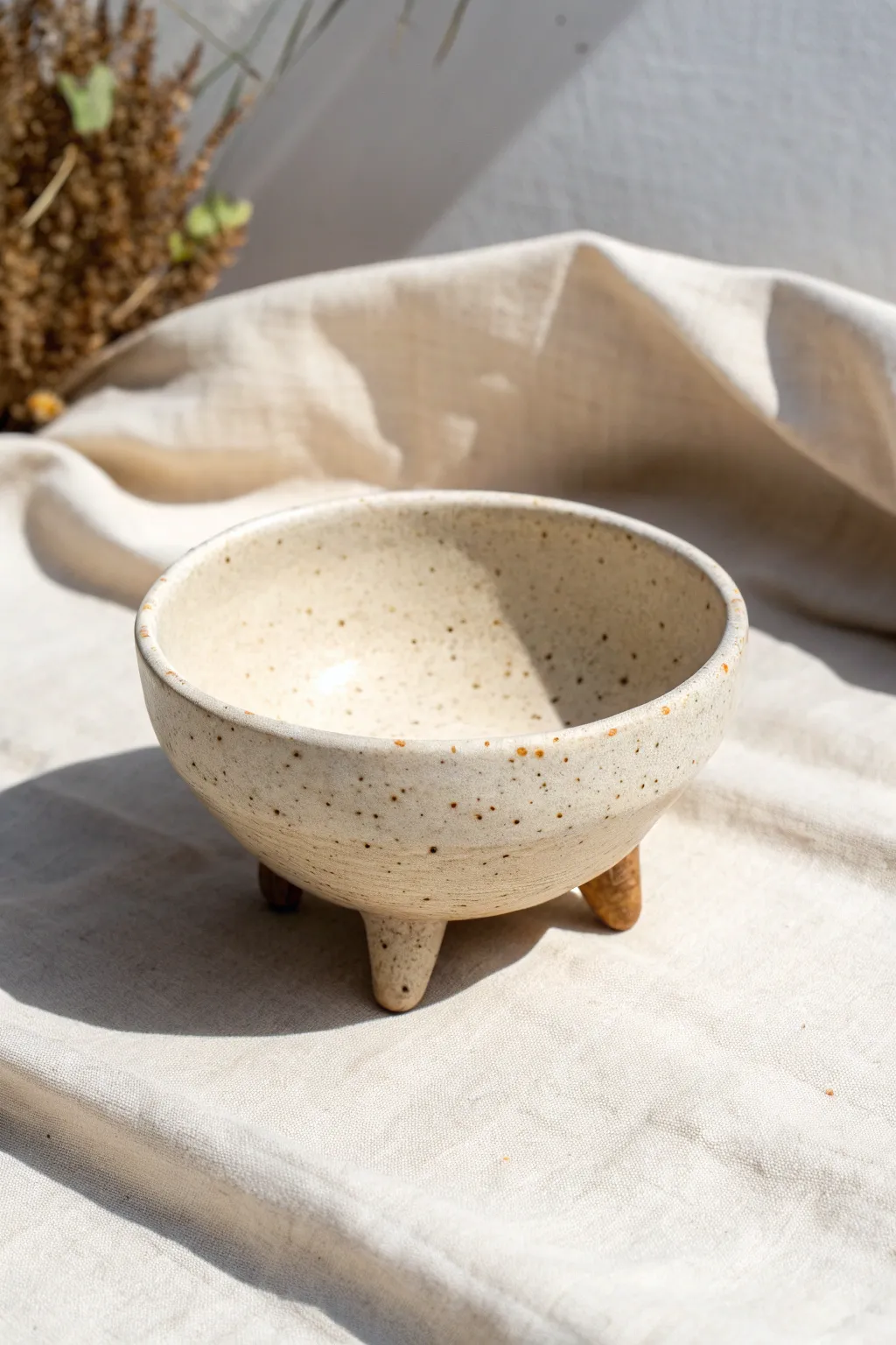 Tripod footed pinch bowl with rounded feet, soft matte clay and calm minimalist styling.
