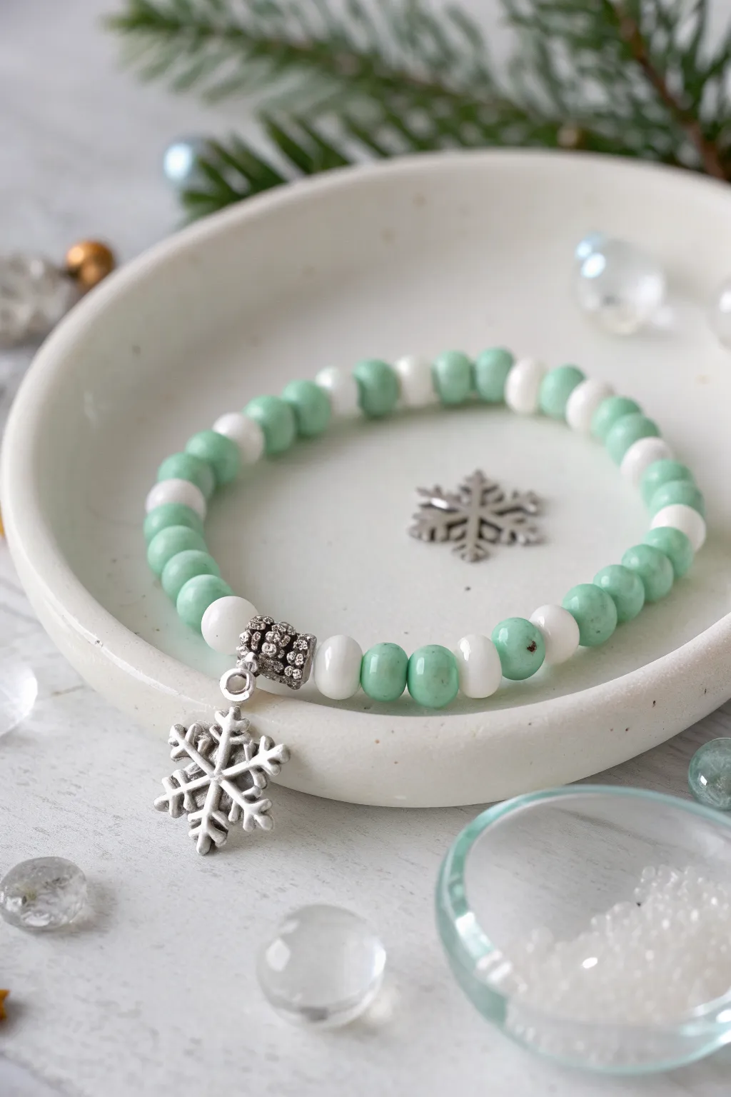 Mint and white heishi bracelet with a snowflake charm for a fresh, modern Christmas look