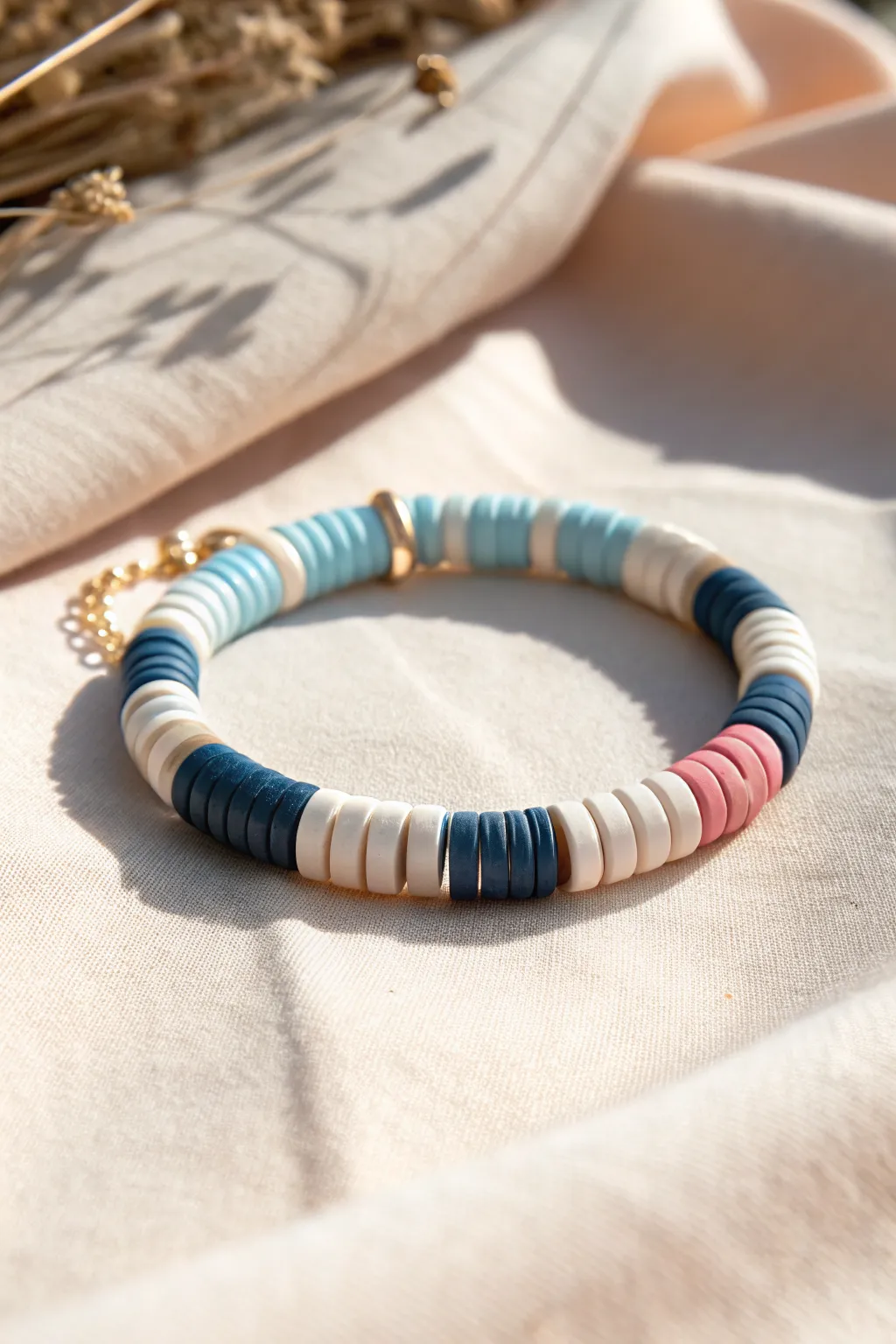 Chunky heishi color blocks in blue, white, navy, with a blush accent for a modern stitch bracelet.