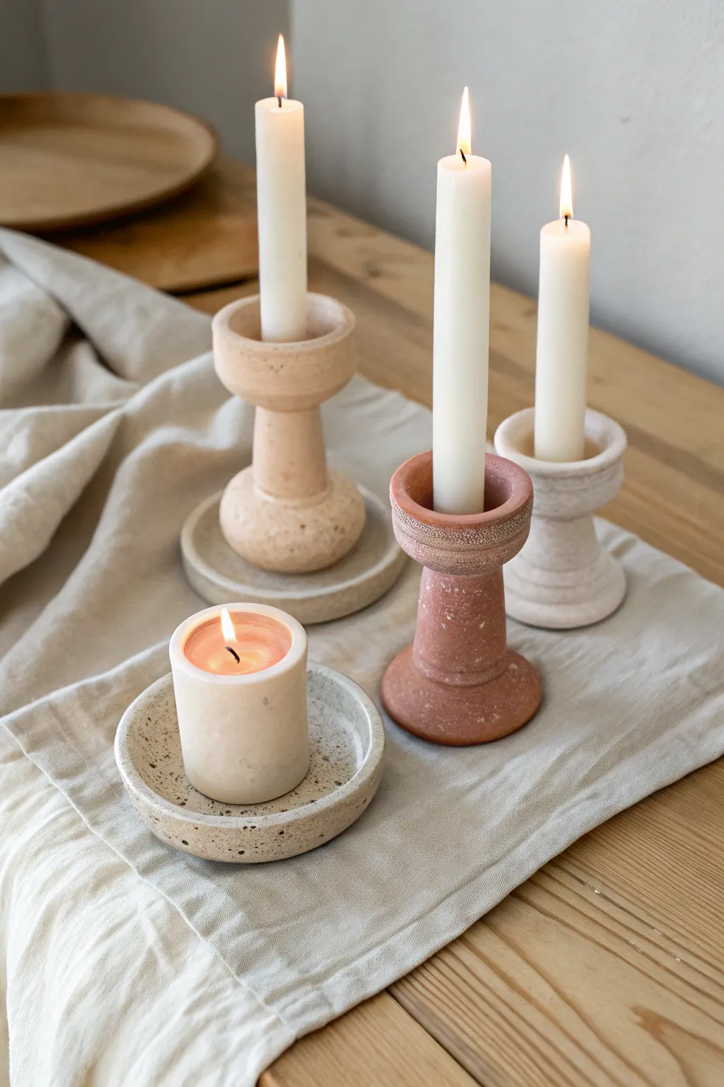 Simple air clay candle holders in soft neutrals for a cozy Scandinavian-boho glow.