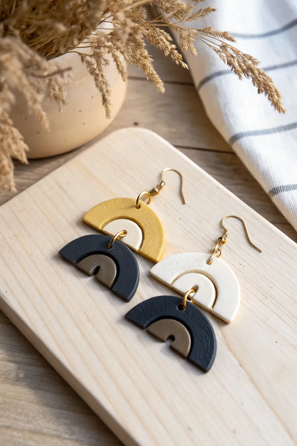 Color-block air-dry clay statement earrings in mustard, cream, and black for a modern boho look.