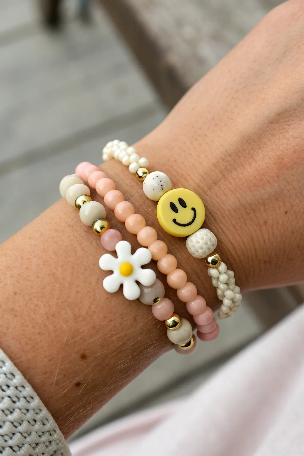 Smiley and flower clay bead birthday stack, soft Scandinavian neutrals with a sunny pop.