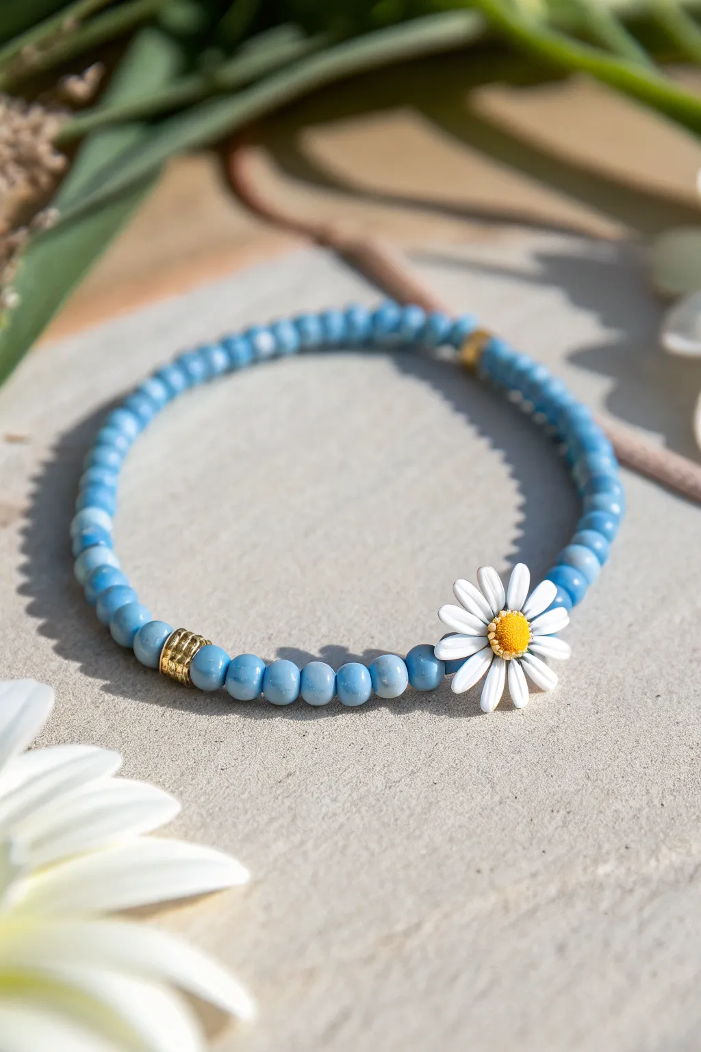 Blue Haven heishi bracelet with white daisy accents, a clean boho summer staple in blue.
