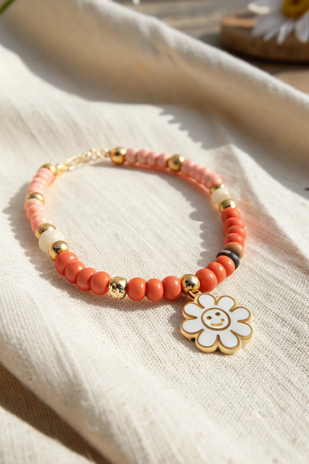 Bright heishi clay bead bracelet with a cheerful smiley or flower focal and gold spacers