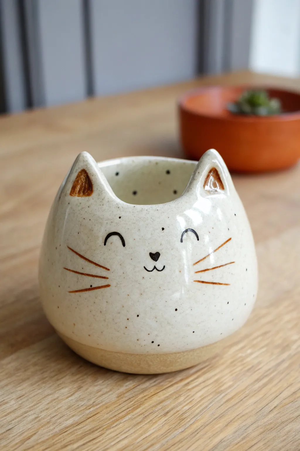 Wide-eyed kitty pinch pot with glossy eyes and soft matte body, minimalist boho styling.