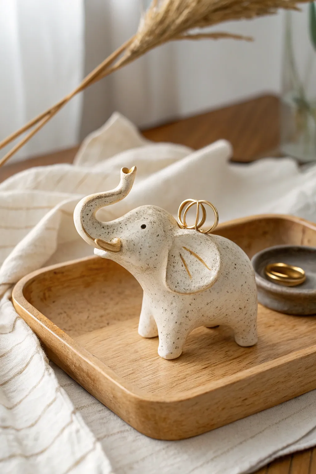 Sweet minimalist elephant ring holder with curved trunk, handmade clay texture, soft boho styling.